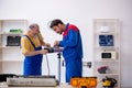 Two male repairmen working at workshop Royalty Free Stock Photo