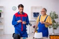Two male repairmen working at workshop Royalty Free Stock Photo