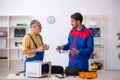 Two male repairmen working at workshop Royalty Free Stock Photo