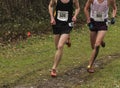 Two cross country runners racing in the rain Royalty Free Stock Photo