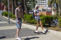 Two male skateboarders taken by surprise as they cruise the main street of Playa Las Americas in Teneriffe Royalty Free Stock Photo