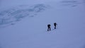 Two male ski mountaineers on a dark foggy morning in the Swiss Alps headed to the Strahlhorn