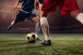 Two male soccer, football players dribbling ball at the stadium during sport match at crowed stadium. Sport concept