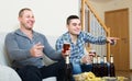 Two male sport fans watching game at home Royalty Free Stock Photo