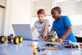 Two Male Students Building And Programing Robot Vehicle In After School Computer Coding Class Royalty Free Stock Photo