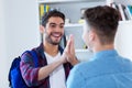 Two male students giving high five Royalty Free Stock Photo