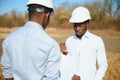 Two male surveyors working at mining site Royalty Free Stock Photo