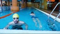 Two male swimmers competing in freestyle stroke at a local swimming pool, good for sport or competition concept Royalty Free Stock Photo