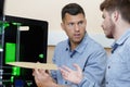 two male technicians discussing prototype from 3d printer