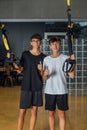 Two male teenagers taking a break after training in gym Royalty Free Stock Photo