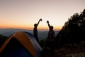 Two male tourists are happy at the top of the mountain. Royalty Free Stock Photo