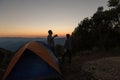 Two male tourists are happy at the top of the mountain. Royalty Free Stock Photo