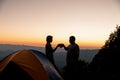 Two male tourists are happy at the top of the mountain. Royalty Free Stock Photo