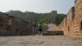 Two male tourists walking through the great wall. Mutianyu section, Beijing, China. View from the ground Royalty Free Stock Photo