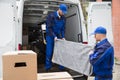 Two Male Worker Unloading Furniture From Truck Royalty Free Stock Photo