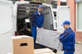 Two Male Worker Unloading Furniture From Truck Royalty Free Stock Photo