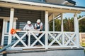 Two male workers on porch inspecting technical document Royalty Free Stock Photo