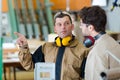 Two male workers talking in carpentry workshop Royalty Free Stock Photo