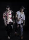Two male zombies standing on black background