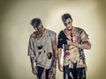 Two male zombies standing on black smoky background Royalty Free Stock Photo