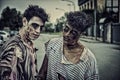 Two male zombies standing in empty city street