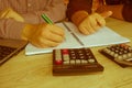 Two man accountants counting on calculator income for tax form completion hands closeup. Internal Revenue Service inspector checki