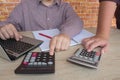 Two man accountants counting on calculator income for tax form completion hands closeup. Internal Revenue Service inspector checki