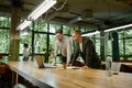 Two man colleagues looking at laptop screen in office Royalty Free Stock Photo