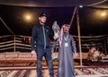 Two man with falcon inside tent in Saudi Arabia