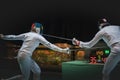 Two man fencing athlete fight on professional sports arena Royalty Free Stock Photo