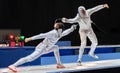 Two man fencing athletes fight