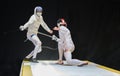 Two man fencing athletes fight