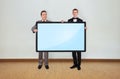 Two man holding plasma Royalty Free Stock Photo