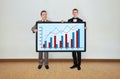 Two man and plasma with graph Royalty Free Stock Photo