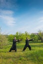 Two man practice tai Chi in a green garden Royalty Free Stock Photo