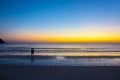 Two man relaxing on the beach at sunrise, beautiful cloudy sky Royalty Free Stock Photo