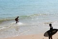 Two Man on a skimboard catching a wave in a beach in Aonang, Krabi ,Thailand Royalty Free Stock Photo