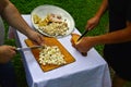 Two man slicing fat with a knifes