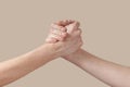 Two man and woman handshake grip hand on beige. Royalty Free Stock Photo