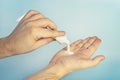 Two man& x27;s hands with opened white cream tube. Man& x27;s hands with white cream tube. hand cream on a blue background Royalty Free Stock Photo