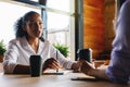 Two managers discussing in cafe Royalty Free Stock Photo