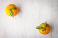 Two mandarins on the white wooden table top view