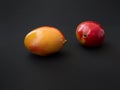 Two mangoes on black the background Royalty Free Stock Photo