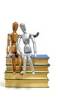 Two mannequins, female and male, are sitting stack of books.Concept of romance novels.