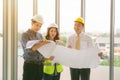 Two mans inspectors and architects discuss with head engineer about construction project