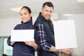 two manual workers holding blank signs