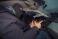 Two masked robbers counting the money they made while sitting in the car they used for the robbery