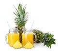 Two mason jars with tasty fresh pineapple juice on white background