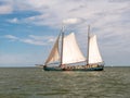 Two-masted clipper and brown fleet charter ship sailing on IJsselmeer lake, Netherlands Royalty Free Stock Photo