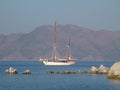 Two-masted schooner sails along the coast Royalty Free Stock Photo